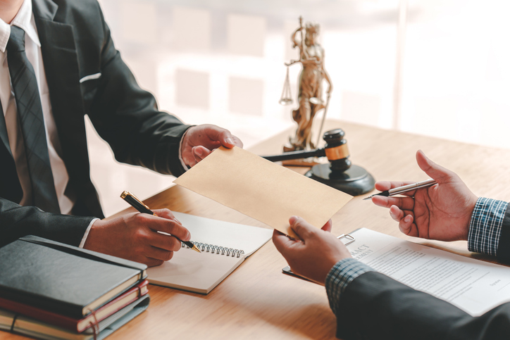 Concepts of corruption in a Toronto tax fraud case, bankruptcy courts, bail, crime, bribery, fraud, Judge Gavel, soundboard, and a handful of cash on the table.