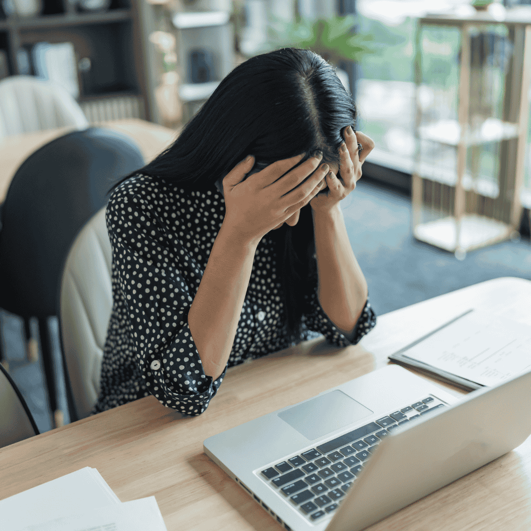 Woman upset browsing online on her laptop
